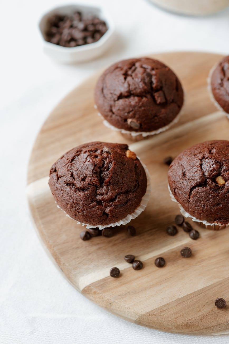 chocolate pastries on wooden board with coffee beans
